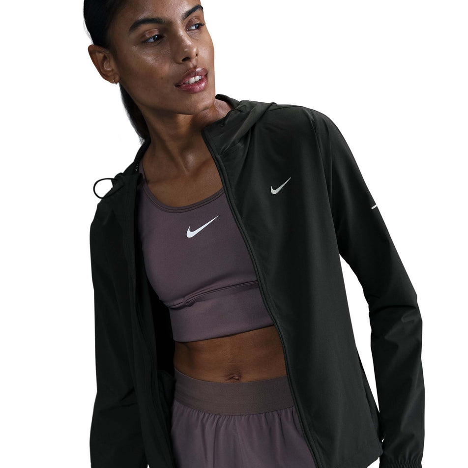 Front view of a model wearing a Nike Women's Swift Repel Packable Running Jacket in the Black/Reflective Silver colourway.  (8560817635490)