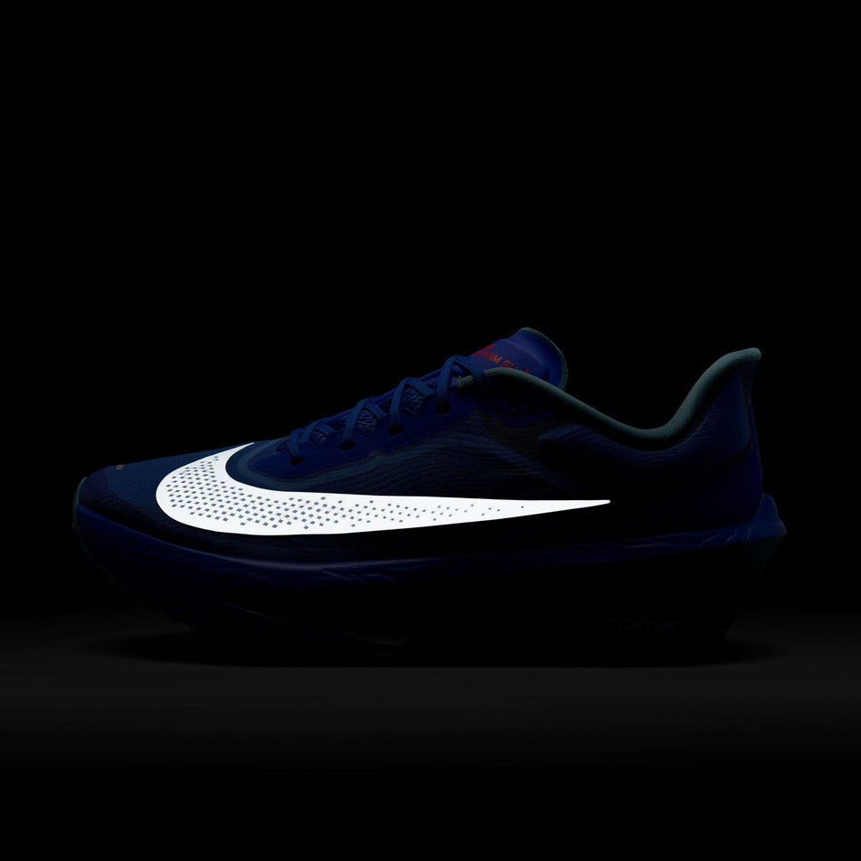 The reflective Swoosh on the lateral side of the left shoe from a pair of Nike Men's Zoom Fly 6 Running Shoes in the Racer Blue/Sail-Denim Turquoise-Doll colourway. (857017489833) (8570174898338)