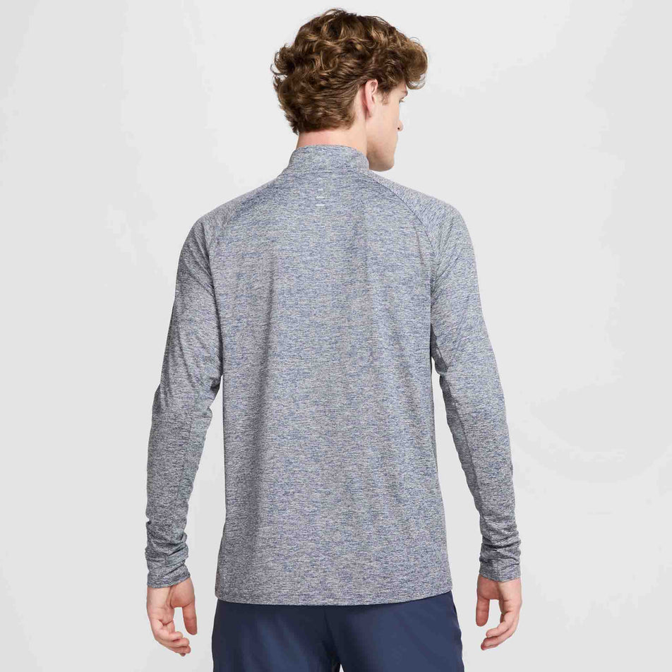 Back view of a model wearing the Nike Men's Stride Dri-FIT Half-Zip Midlayer in the Thunder Blue/Heather/Reflective Silver colourway. (8560377069730)