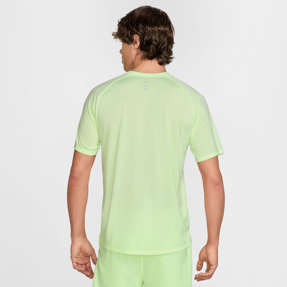 Back view of a model wearing the Nike Men's Stride Dri-FIT ADV Short-Sleeve Running Top in the Barely Volt/Reflective Silver colourway. (8560175513762)