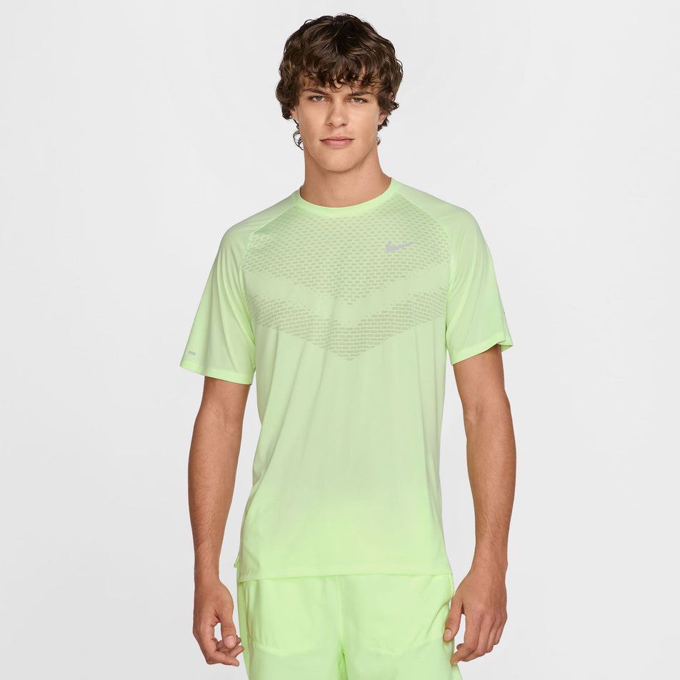 Front view of a model wearing the Nike Men's Stride Dri-FIT ADV Short-Sleeve Running Top in the Barely Volt/Reflective Silver colourway. (8560175513762)