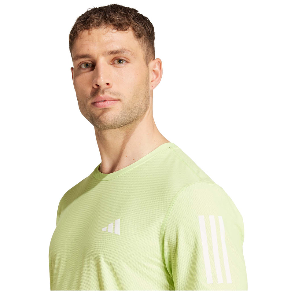 Front view of a model wearing the adidas Men's Own The Run Base Tee in the Pulse Lime colourway. (8566977003682)