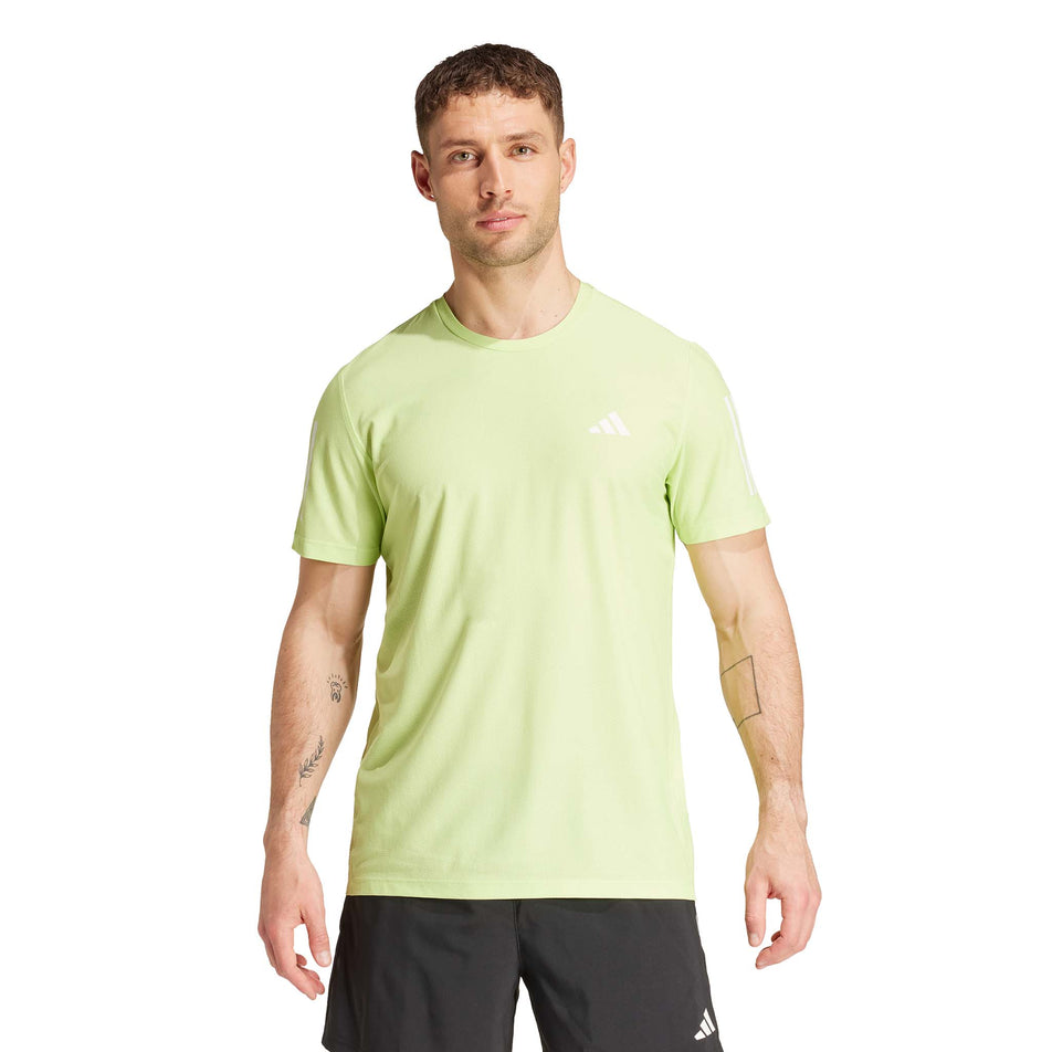 Front view of a model wearing the adidas Men's Own The Run Base Tee in the Pulse Lime colourway. (8566977003682)