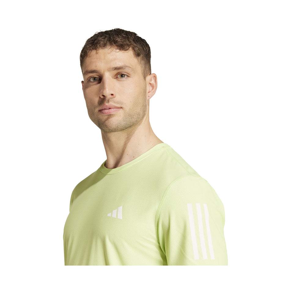 The upper section of an adidas Men's Own The Run T-Shirt in the Pulse Lime colourway. Top is being worn by a model. (8457446949026)