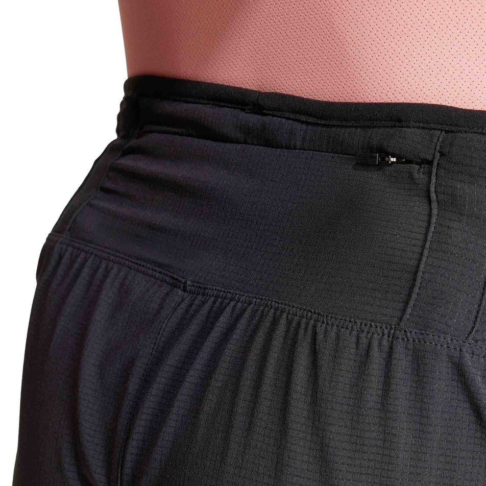 Close-up view of the back of the waistband on a pair of adidas Men's Adizero Running Gel Short in the black colourway. Shorts are being worn by a model. (8449511850146)