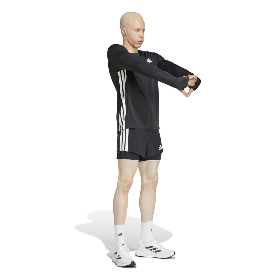 Front view of a model wearing the adidas Men's Adizero 2in1 Short in the Black colourway.  (8566982148258)