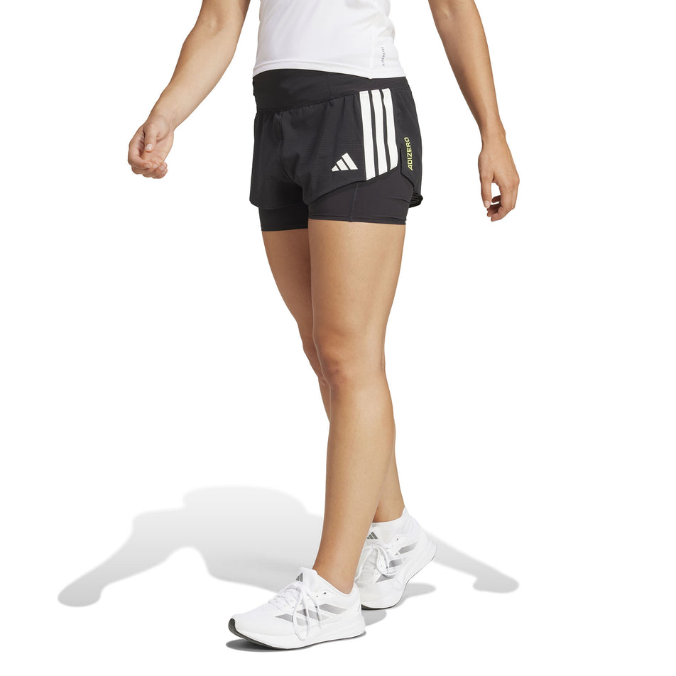 Front view of a model wearing the adidas Women's Adizero 2in1 Short in the Black colourway. (8567010525346)