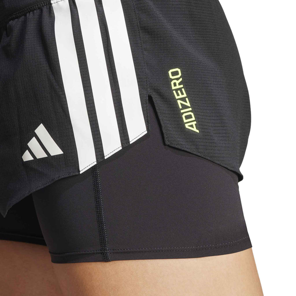 Close-up view of the left side of the adidas Women's Adizero 2in1 Short in the Black colourway. (8567010525346)