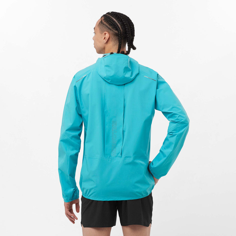 Back view of a model wearing a Salomon Men's Bonatti Trail Jacket in the Peacock Blue colourway. Model is also wearing Salomon shorts. (8157810655394)