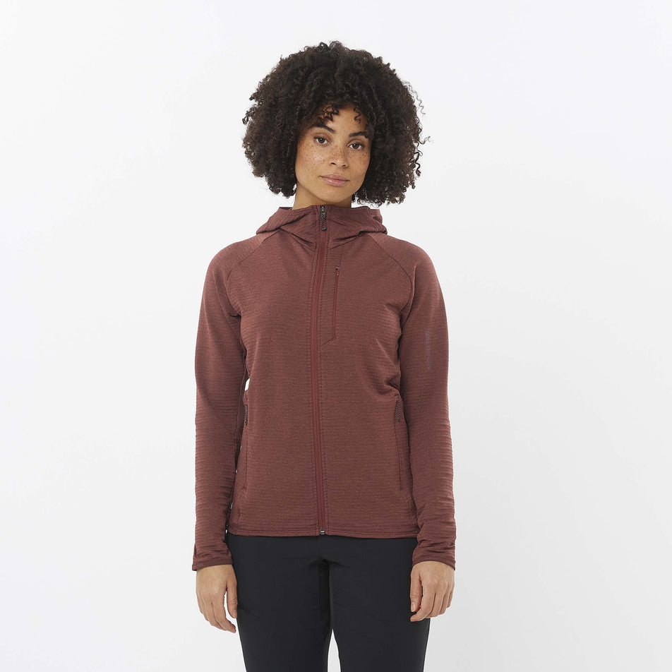 Front view of a model wearing the Salomon Women's Essential Lightwarm Midlayer Jacket Hoodie in the Rum Raisin colourway. Model is also wearing leggings.  (8509527097506)