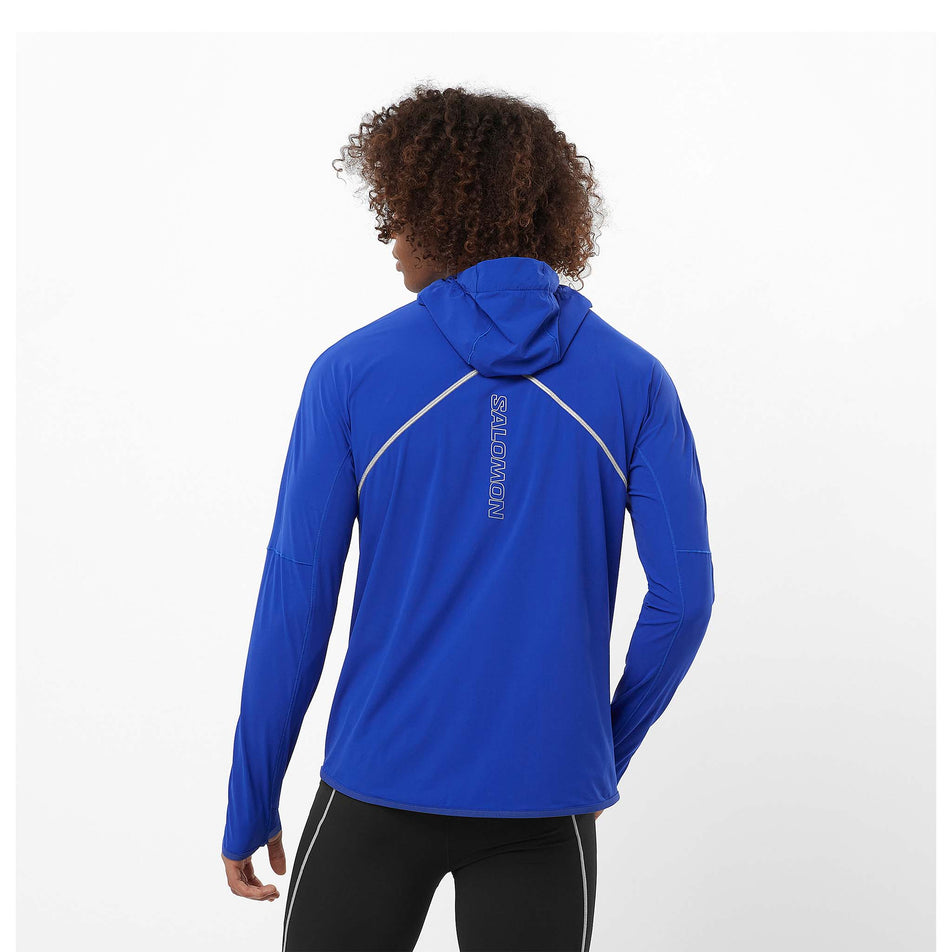 Back view of a model wearing a Salomon Men's Sense Aero Hybrid Midlayer Jacket with hood in the Surf The Web colourway. Model is also wearing legwear.  (8464251617442)