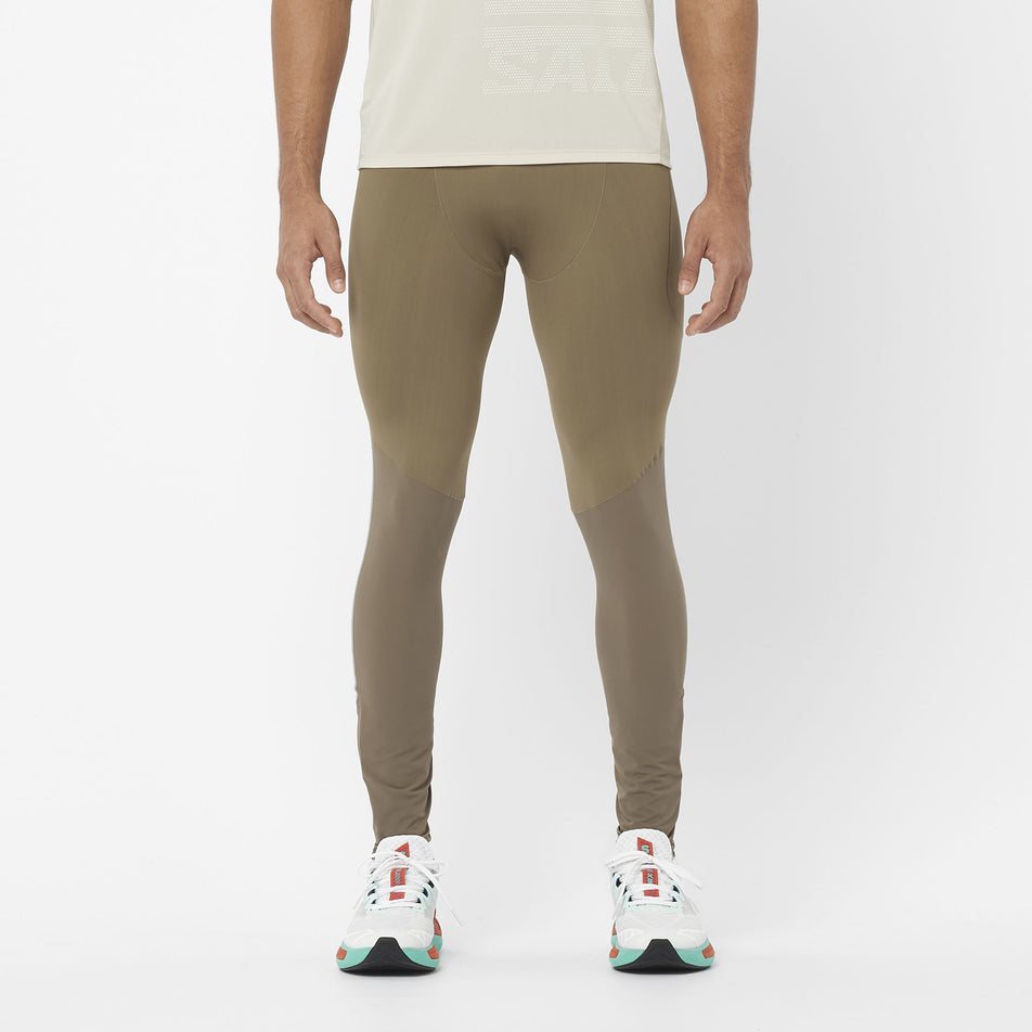 Front view of a model wearing the Salomon Men's Sense Aero Stow Tights in the Shitake colourway. Model is also wearing a top and shoes.  (8509599318178)