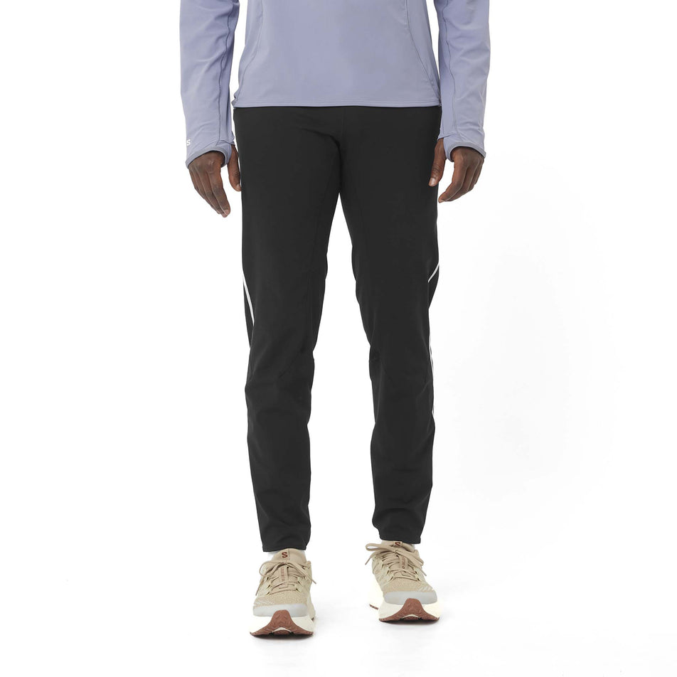 Front view of a model wearing the Salomon Men's Salomon Sense Aero Stow Pants in the Deep Black colourway. (8575579029666)