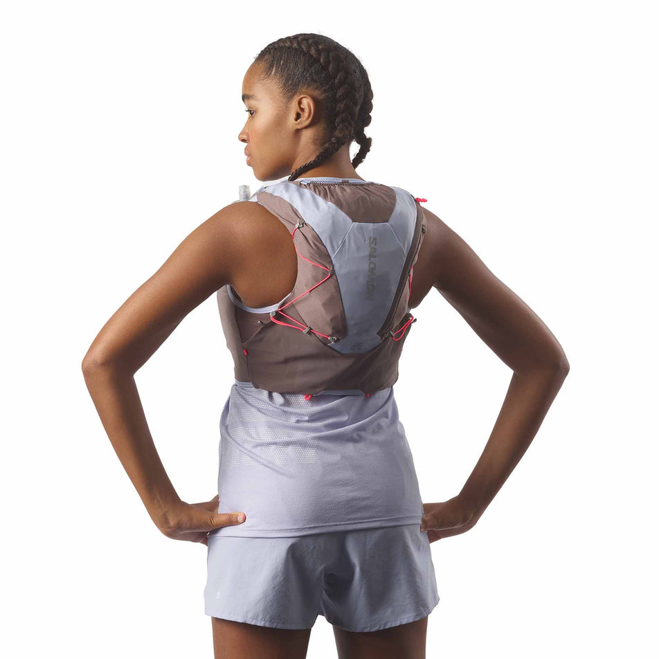 Back view of a model wearing the Salomon Women's ADV Skin 12 Running Vest with flasks included in the Nine Iron/Excalibur/Cosmic Sky colourway. (8575892521122)