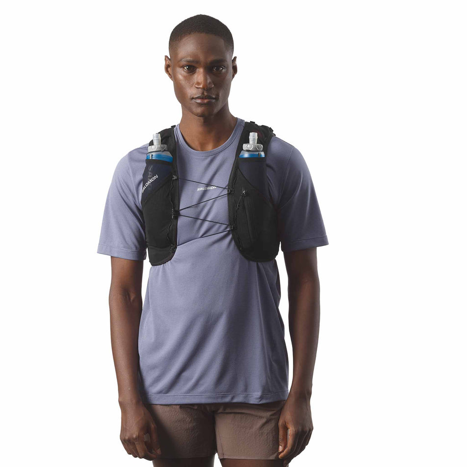 Front view of a model wearing the Salomon Unisex ADV Skin 5 Running Vest with flasks included in the Black colourway. (8575893307554)