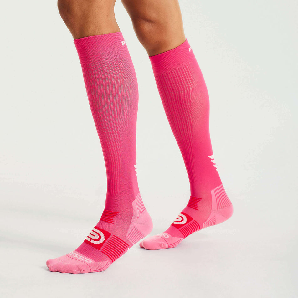 Side view of a model wearing the Pressio Unisex EQ Compression Socks in the Pink/Red colourway. (8341600632994)