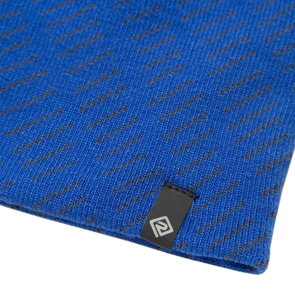 Close-up of the Ronhill logo and fabric on the Ronhill Unisex Classic Beanie. (8491323850914)