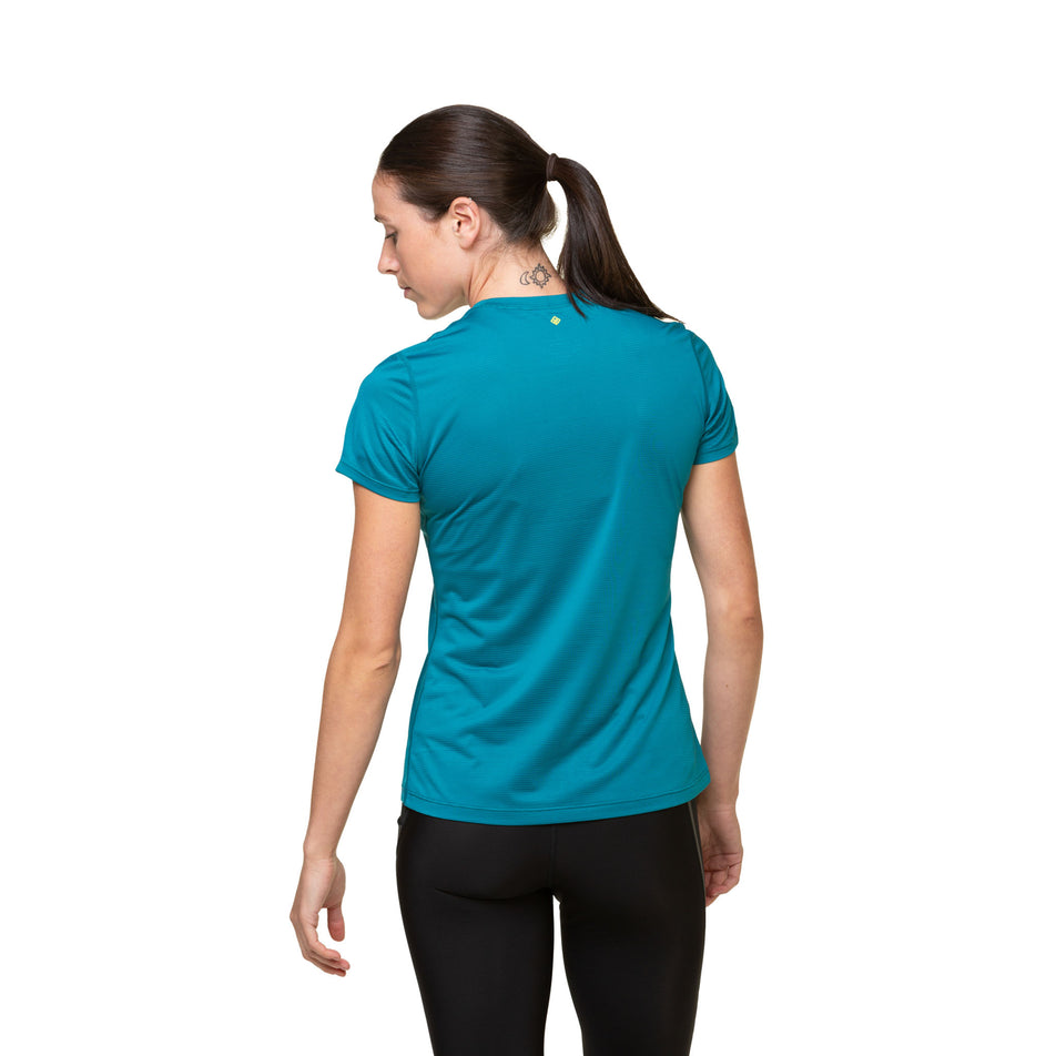 Back view of a model wearing the Ronhill Women's Tech S/S Tee in the Marine/Acid colourway. Model is also wearing leggings. (8490105634978)