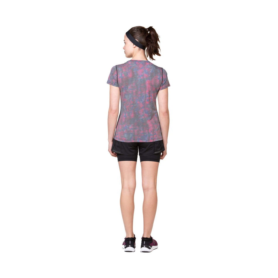 Back view of a model wearing the Ronhill Women's Tech Golden Hour Tee in the Multi Daydream colourway. (8564967375010)