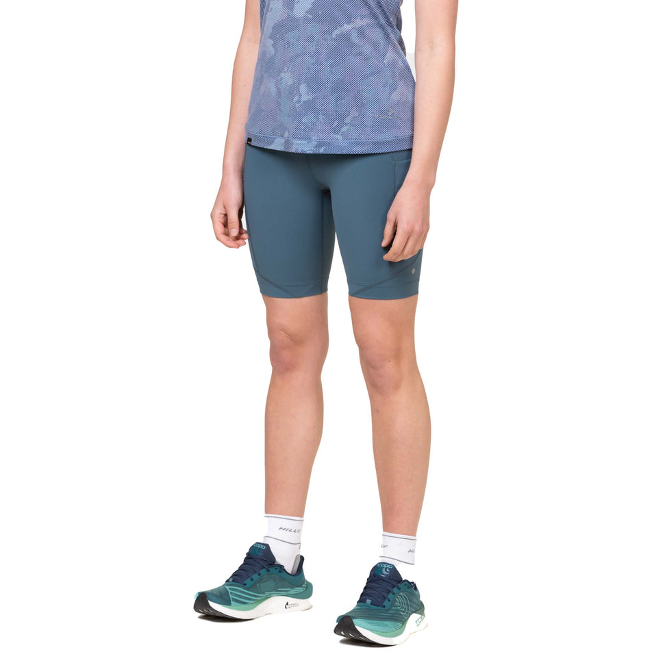 Front view of a model wearing the Ronhill Women's Tech Stretch Short in the Dark Mallard colourway. (8581026349218)