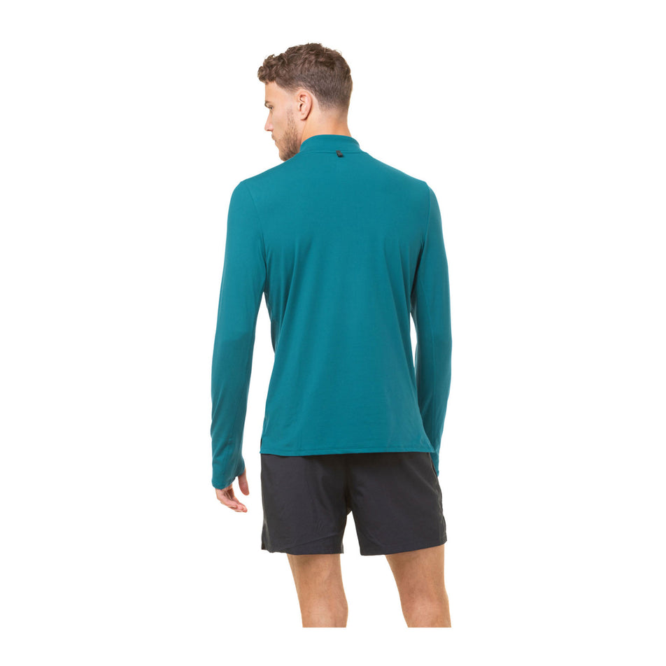 Back view of a model wearing a Ronhill Men's Core Thermal 1/2 Zip in the Deep Teal/Acid colourway. Model is also wearing shorts. (8470840705186)