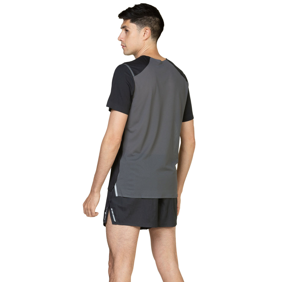 Back view of a model wearing the Ronhill Men's Tech Race S/S Tee in the Black/Artemis colourway. (8583523696802)