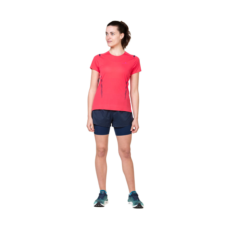 Front view of a model wearing the Ronhill Women's Tech Race Twin Short in the Dark Navy/Razzmatazz colourway. (8583390822562)