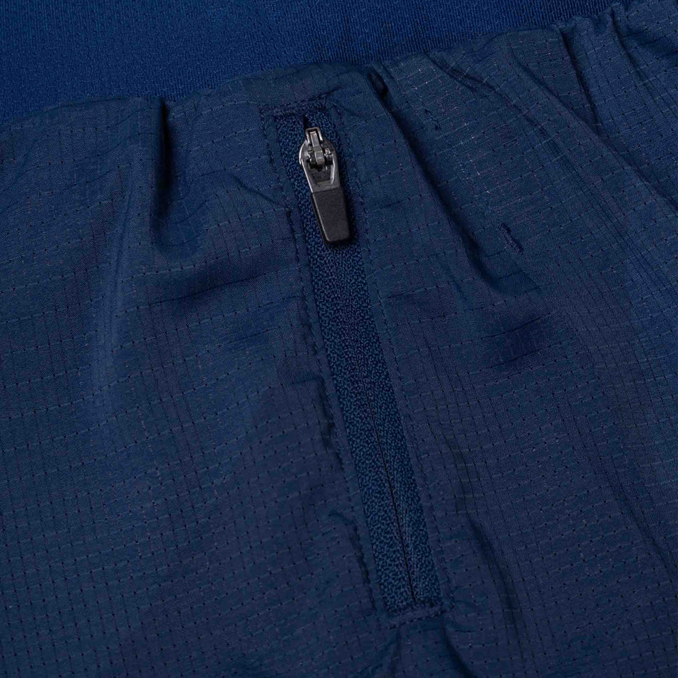 The zip pocket on the Ronhill Women's Tech Race Twin Short in the Dark Navy/Razzmatazz colourway. (8583390822562)