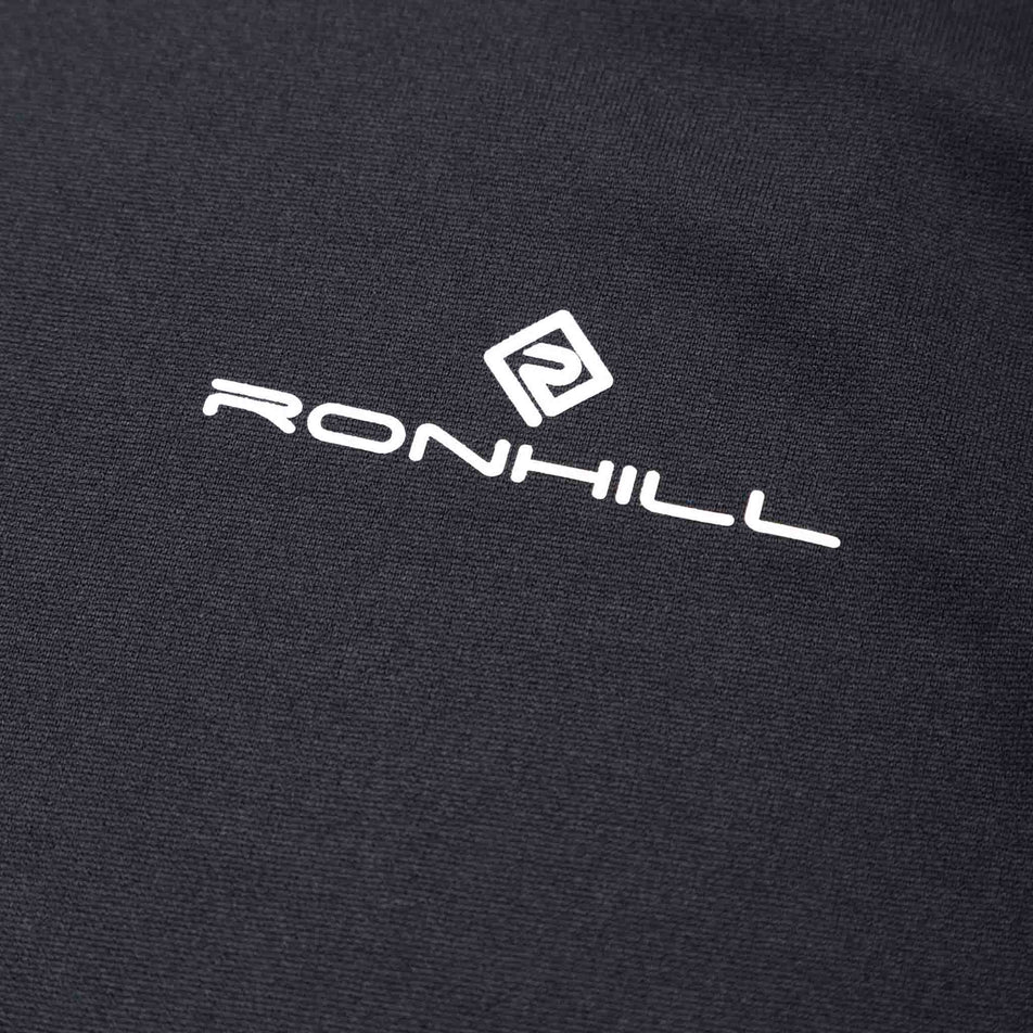 Close-up of the Ronhill logo and fabric on the front of the Ronhill Men's Core Vest in the Black/Bright White colourway. (8490972020898)