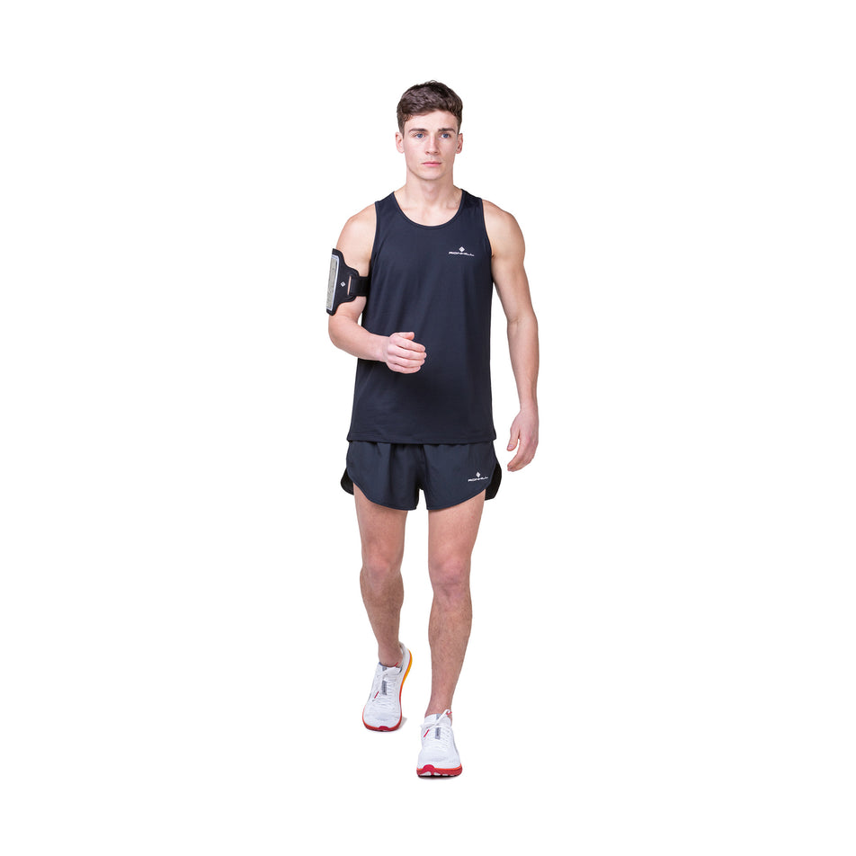 Front view of a model wearing the Ronhill Men's Core Vest in the Black/Bright White colourway. Model is also wearing shoes and shorts. (8490972020898)