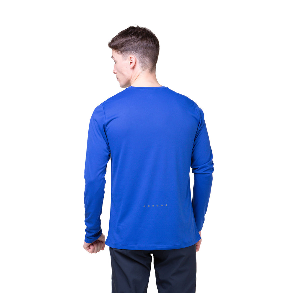 Back view of a model wearing a Ronhill Men's Core L/S Tee in the Dark Cobalt/Bright White colourway. Model is also wearing legwear. (8468452049058)