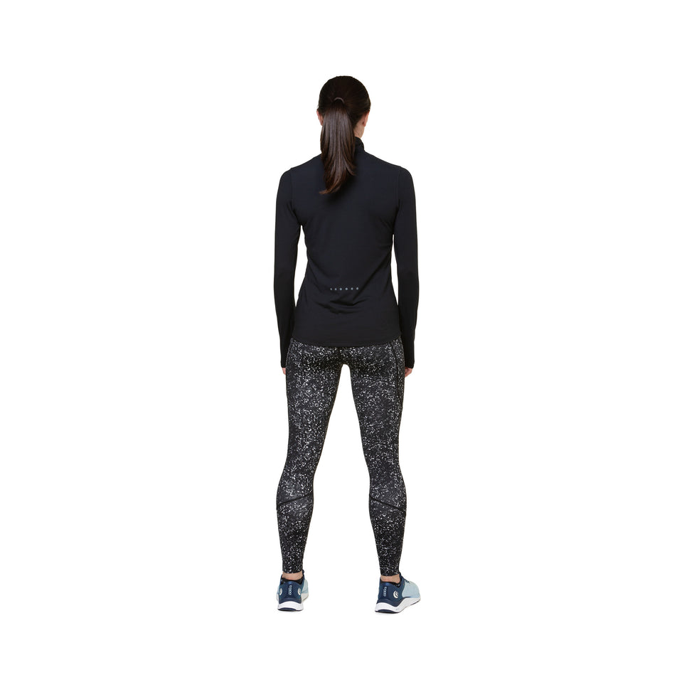 Back view of a model wearing the Ronhill Women's Tech Tight in the Mono Sprinkle colourway. Model is also wearing shoes and a top. (8490012737698)