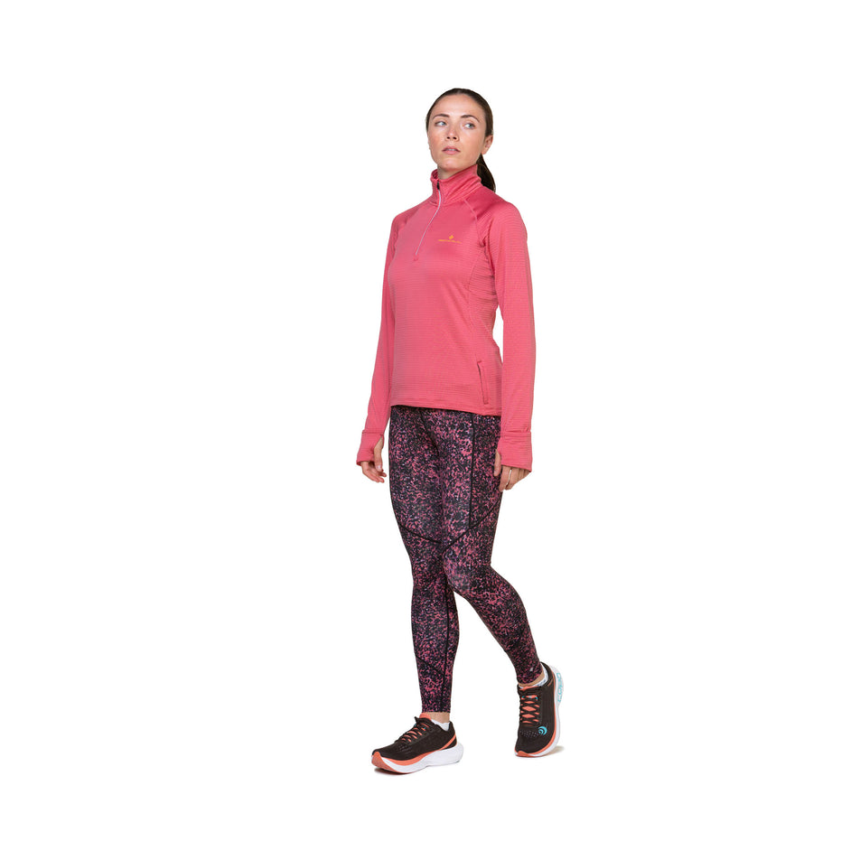 Front view of a model wearing the Ronhill Women's Tech Tight in the Salsa Sprinkle colourway. Model is also wearing shoes and a top. (8490025058466)