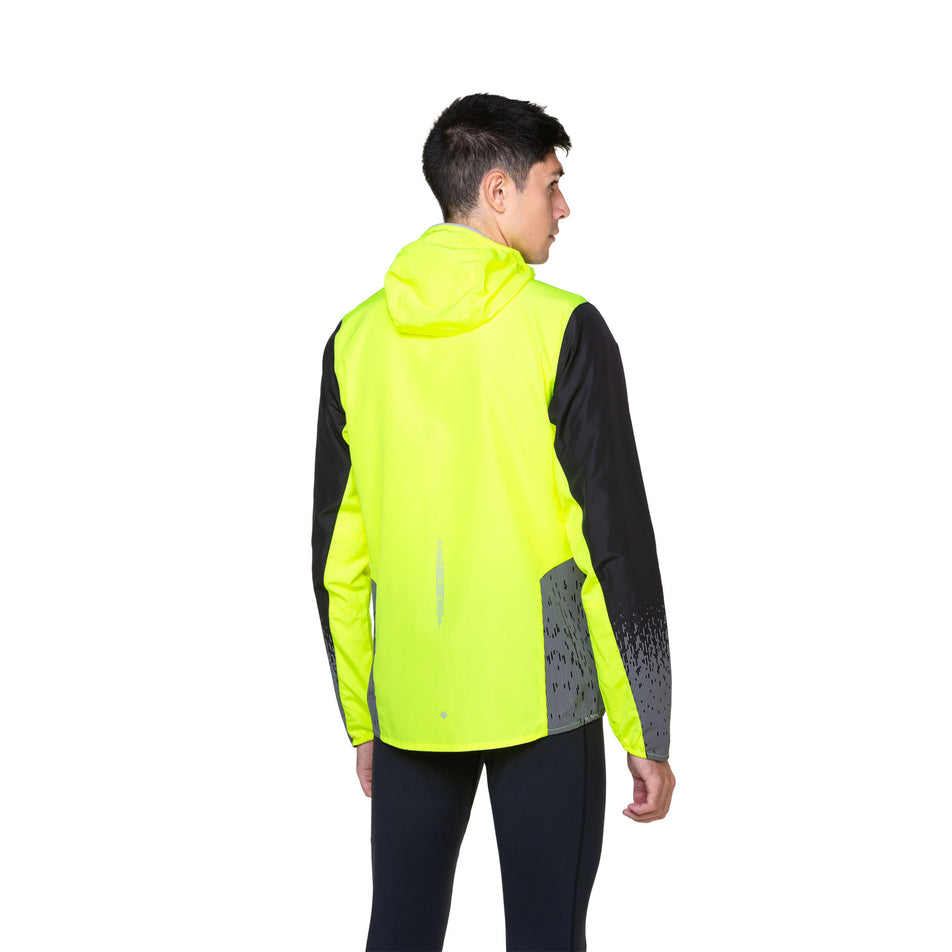 Back view of a model wearing a Ronhill Men's Tech Reflect Jacket in the Fluo Yellow/Black/Reflect colourway. Model is also wearing leggings.  (8490189095074)