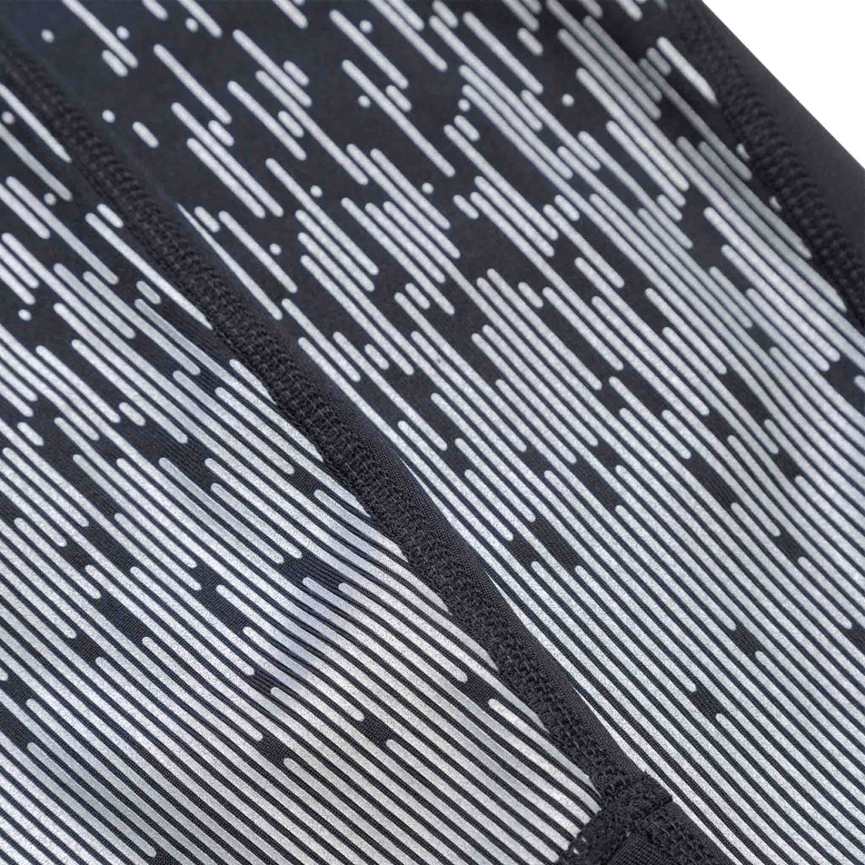 Close-up of some of the reflective details on the Ronhill Men's Tech Reflect Tight in the Black/Reflect colourway. (8469653848226)