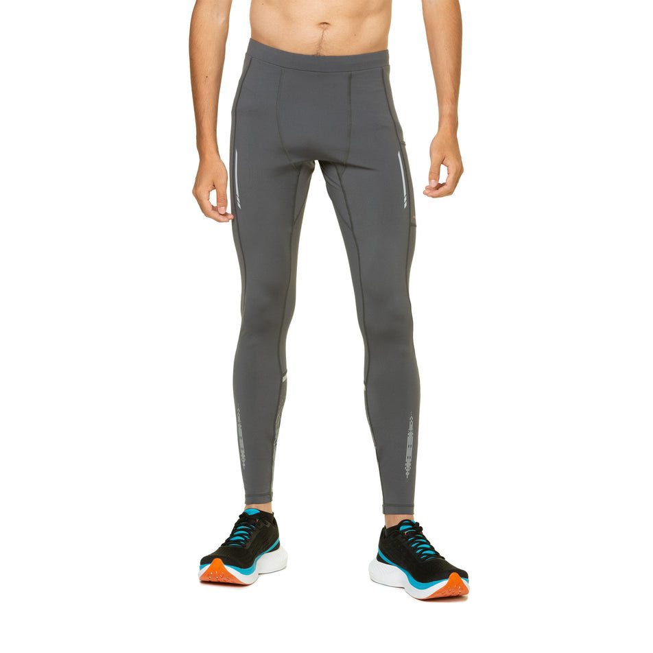 Front view of a model wearing the Ronhill Men's Tech Reflect Tight in the Iron/Reflect colourway. Model is also wearing shoes. (8490232447138)