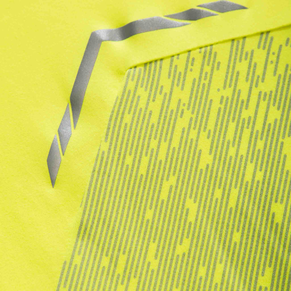 Close-up of some of the reflective details on a Ronhill Men's Tech Reflect 1/2 Zip in the Fluo Yellow/Reflect colourway.  (8469627207842)