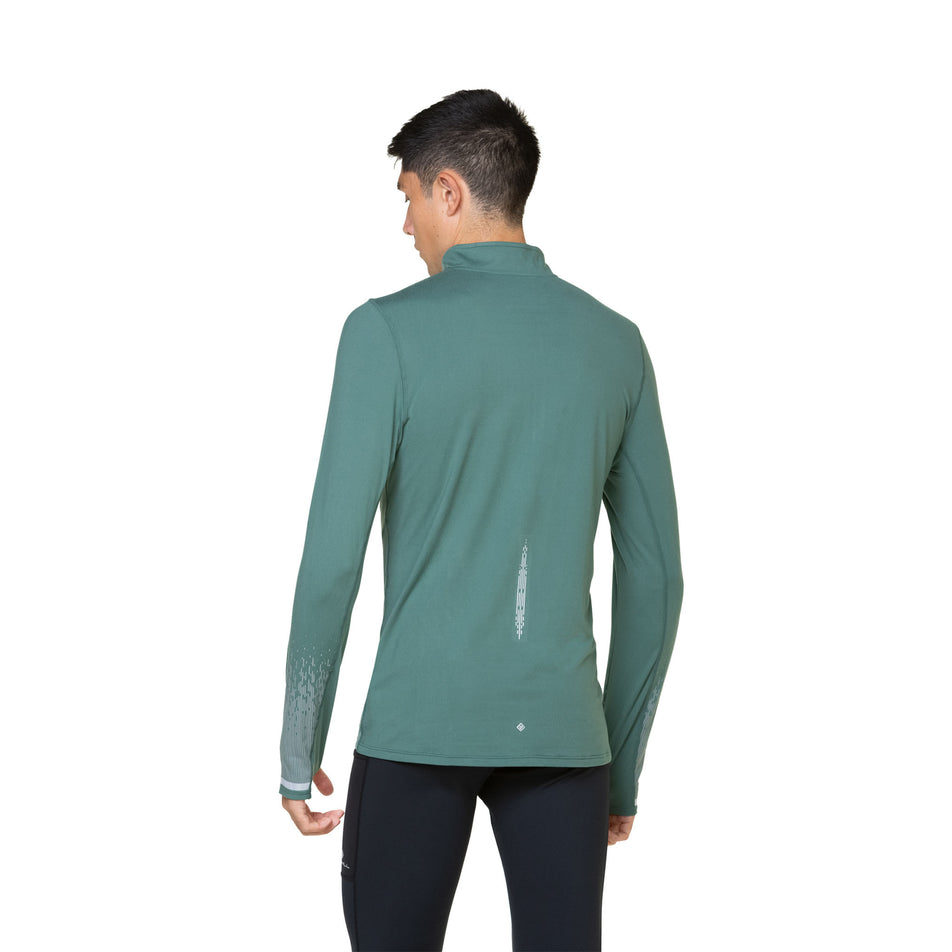 Back view of a model wearing a Ronhill Men's Tech Reflect 1/2 Zip in the Dark Sage/Reflect colourway. Model is also wearing leggings. (8490203938978)