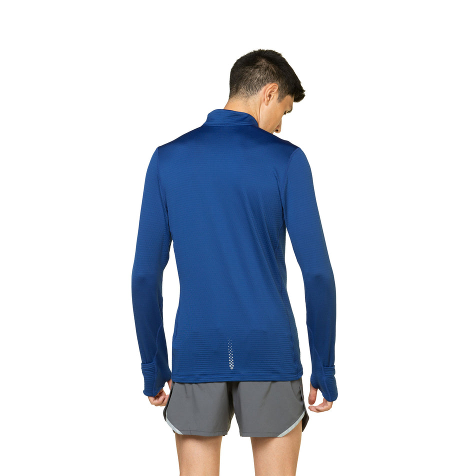 Back view of a model wearing the Ronhill Men's Tech Winter 1/2 Zip in the Ocean/Iron colourway. Model is also wearing shorts. (8491275387042)