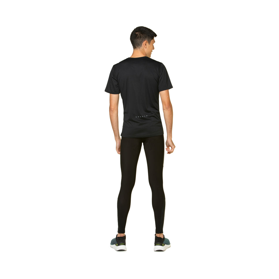 Back view of a model wearing the Ronhill Men's Tech GORE-TEX Windstopper Tight in the All Black colourway. Model is also wearing shoes and a top. (8490245587106)