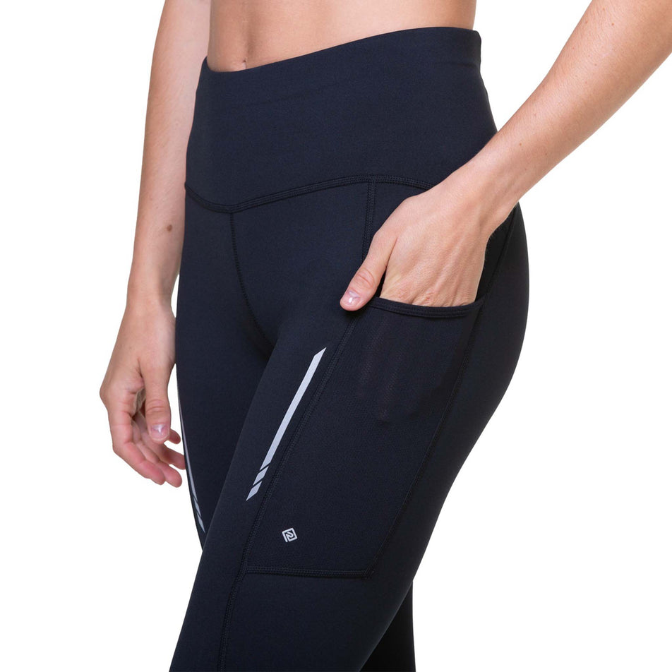 A model highlighting the stretch pocket on the outside of the leg of the Ronhill Women's Tech Reflect Tight (8469261287586)