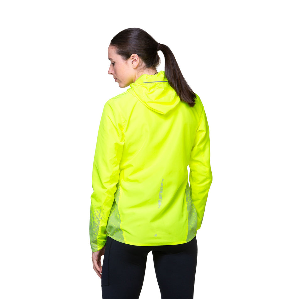 Back view of a model wearing a Ronhil Women's Tech Reflect Jacket in the Fluo Yellow/Reflect colourway. Model is also wearing leggings. (8468472463522)