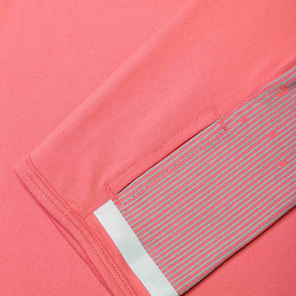 Close-up of the reflective details on the sleeve of a Ronhill Women's Tech Reflect 1/2 Zip in the Salsa/Reflect colourway.  (8469213249698)