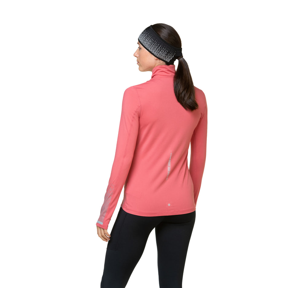 Back view of a model wearing a Ronhill Women's Tech Reflect 1/2 Zip in the Salsa/Reflect colourway. Model is also wearing leggings and a headband.  (8469213249698)