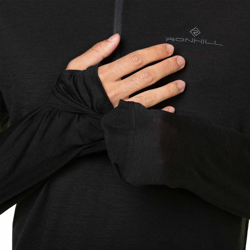 A model demonstrating the integrated mittens and hand covers on a Ronhill Men's Tech Merino 1/2 Zip. The top is being worn by the model.  (8490269573282)