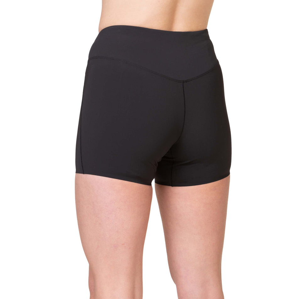 Back view of a model wearing the Ronhill Women's Tech Race Stretch Short in the All Black colourway. (8563585089698)