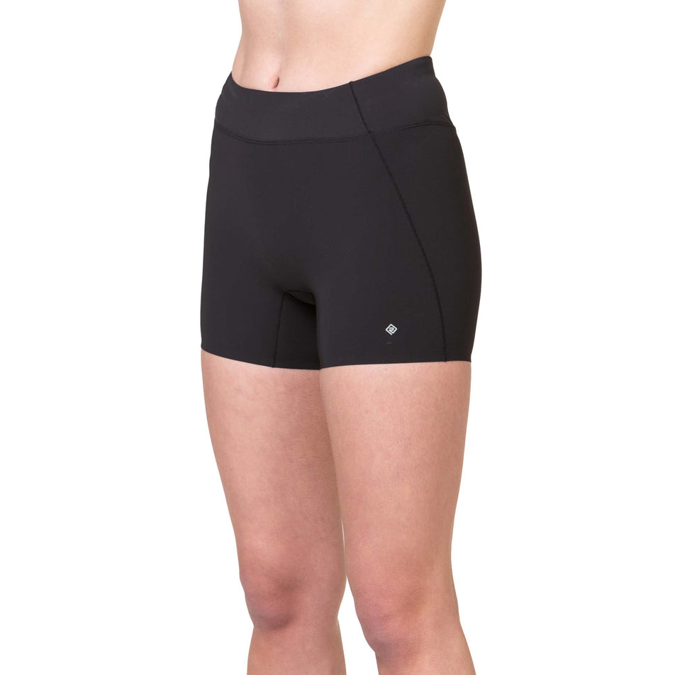 Front view of a model wearing the Ronhill Women's Tech Race Stretch Short in the All Black colourway. (8563585089698)