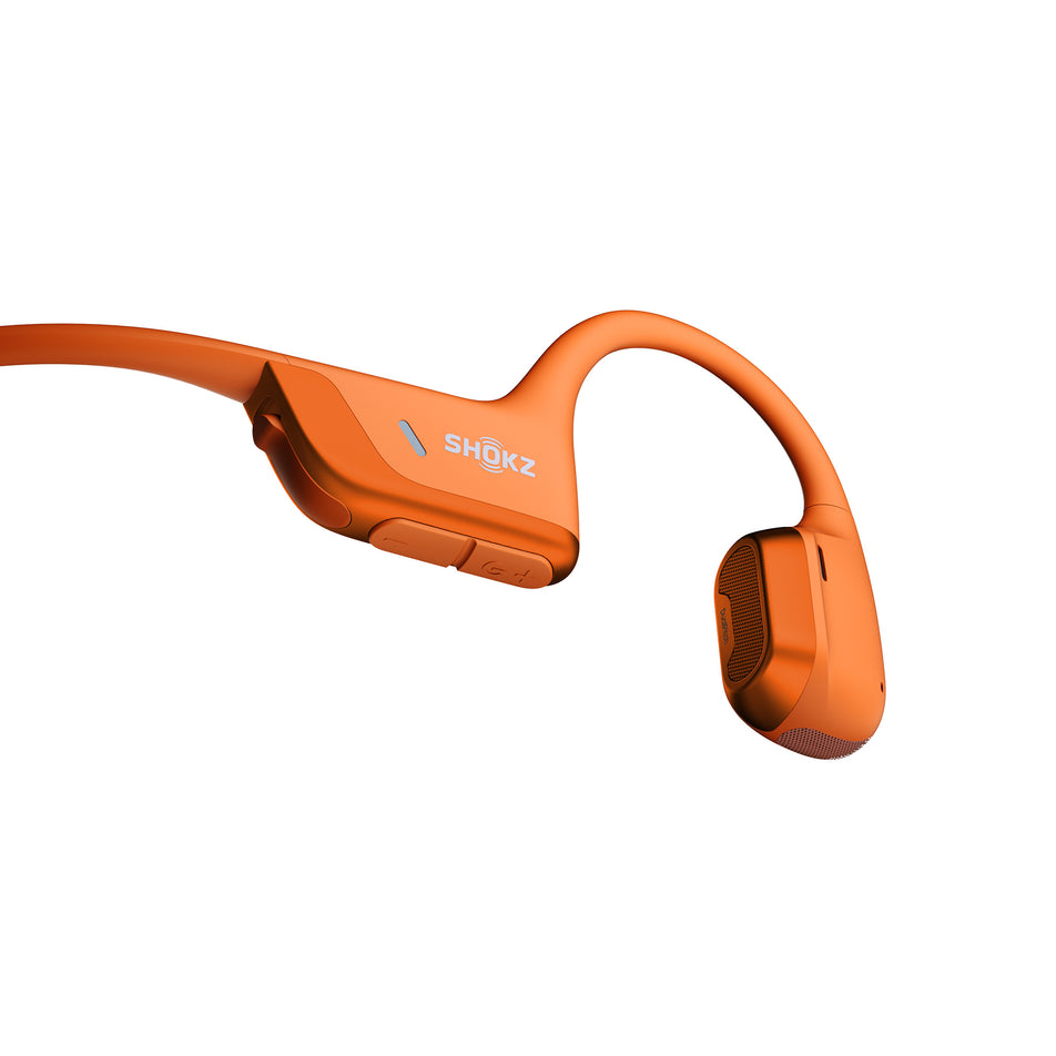 Close-up of the controls on the right earbud of pair of Shokz Unisex OpenRun Pro 2 Wireless Bone Conduction Headphones in the Orange colourway.  (8541428088994)