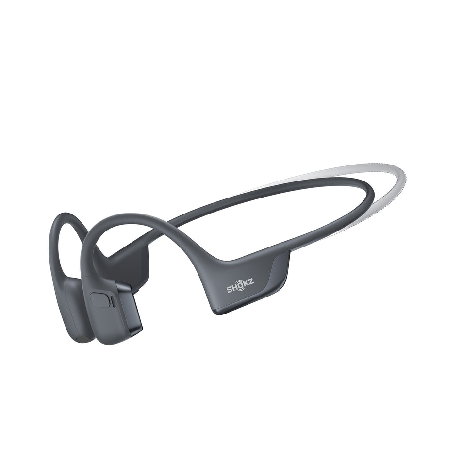 A pair of Shokz Unisex OpenRun Pro 2 Mini Wireless Bone Conduction Headphones, in the Black colourway, against the outline of the standard size.  (8541430087842)