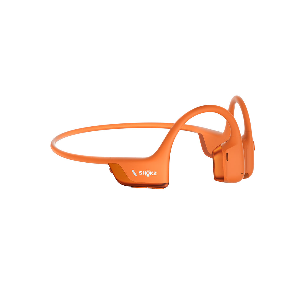 A pair of Shokz Unisex OpenRun Pro 2 Mini Wireless Bone Conduction Headphones in the Orange colourway.   (8541433299106)